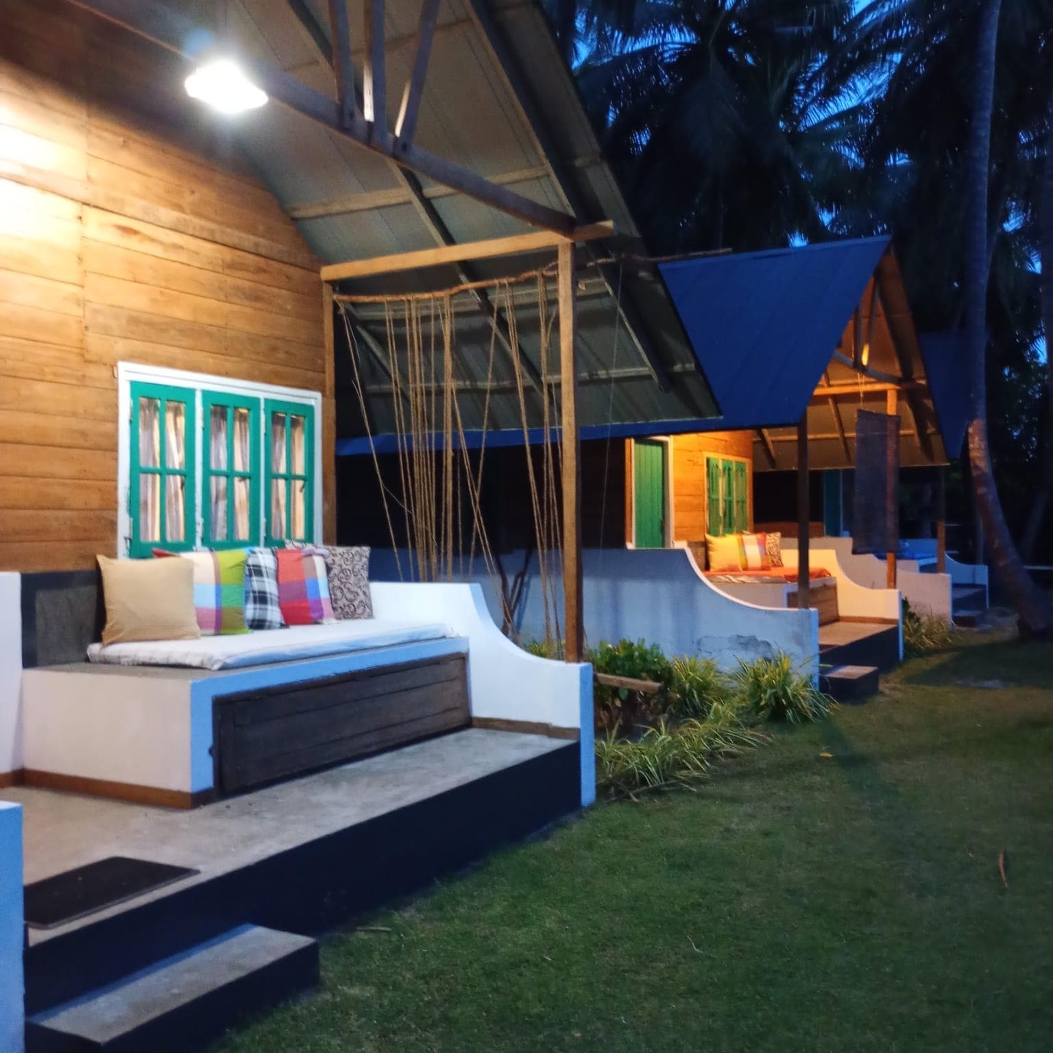 The row of cabanas lit up at dusk