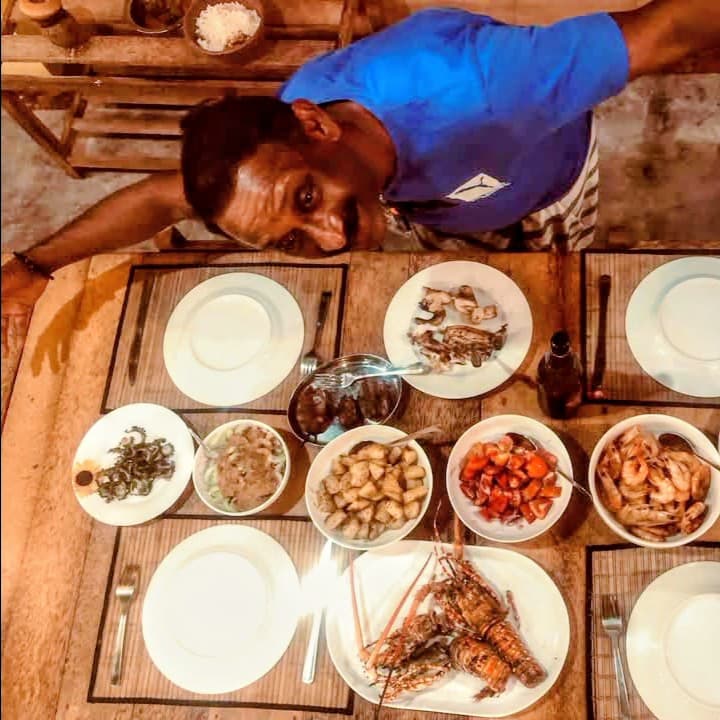 The chef with a fresh seafood spread — lobster, prawns and curries
