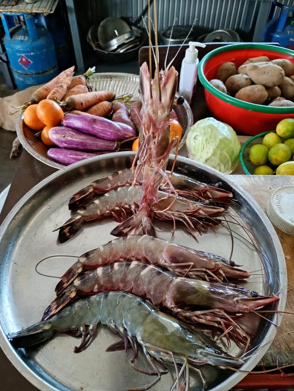 Fresh prawns and market vegetables in the kitchen