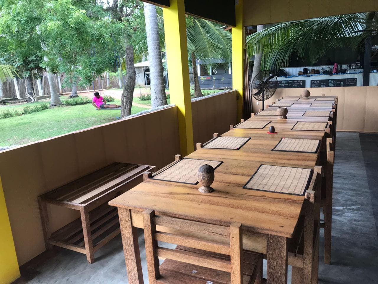 The long wooden table in the open-air restaurant