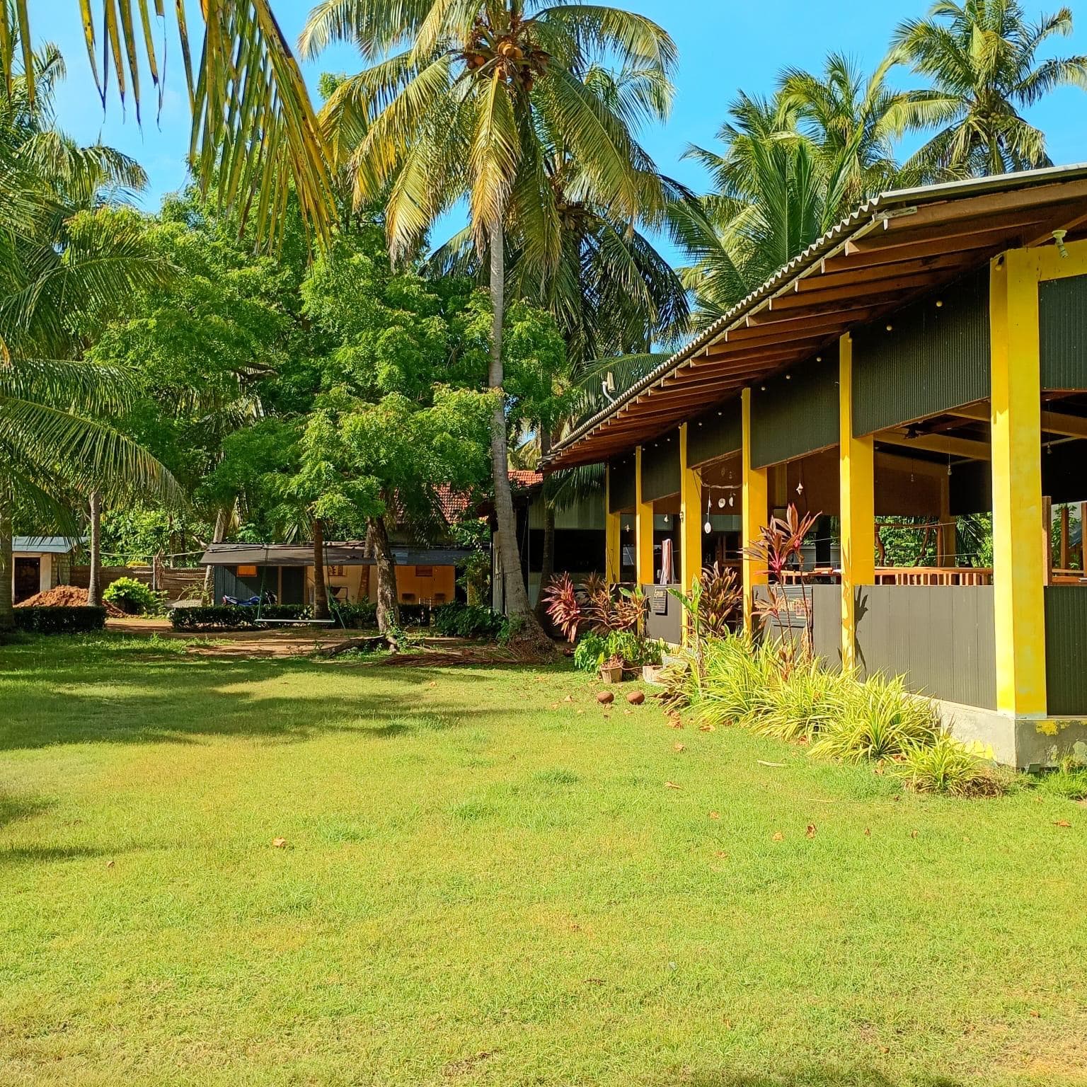 The open-air restaurant seen across the garden flowers